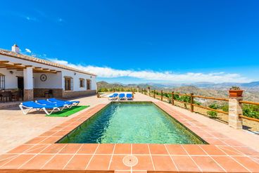 Modern villa on a hilltop, with striking views over the valley