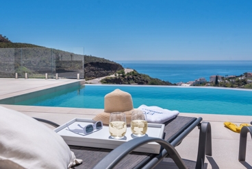 Maison moderne avec piscine à débordement et vue sur la mer